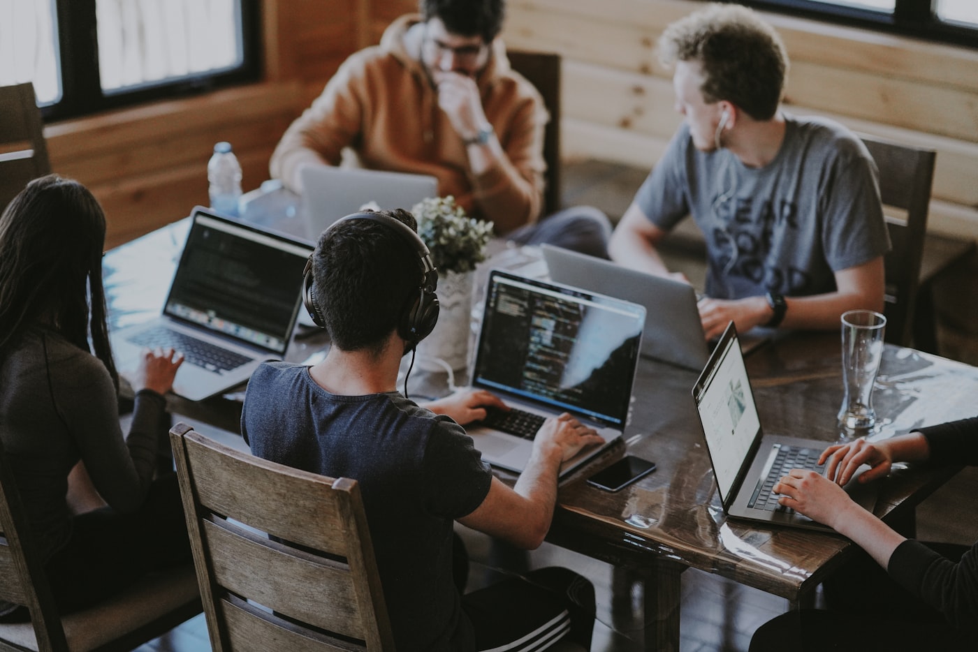 The CyberStrek team collaborating around laptops in a modern office